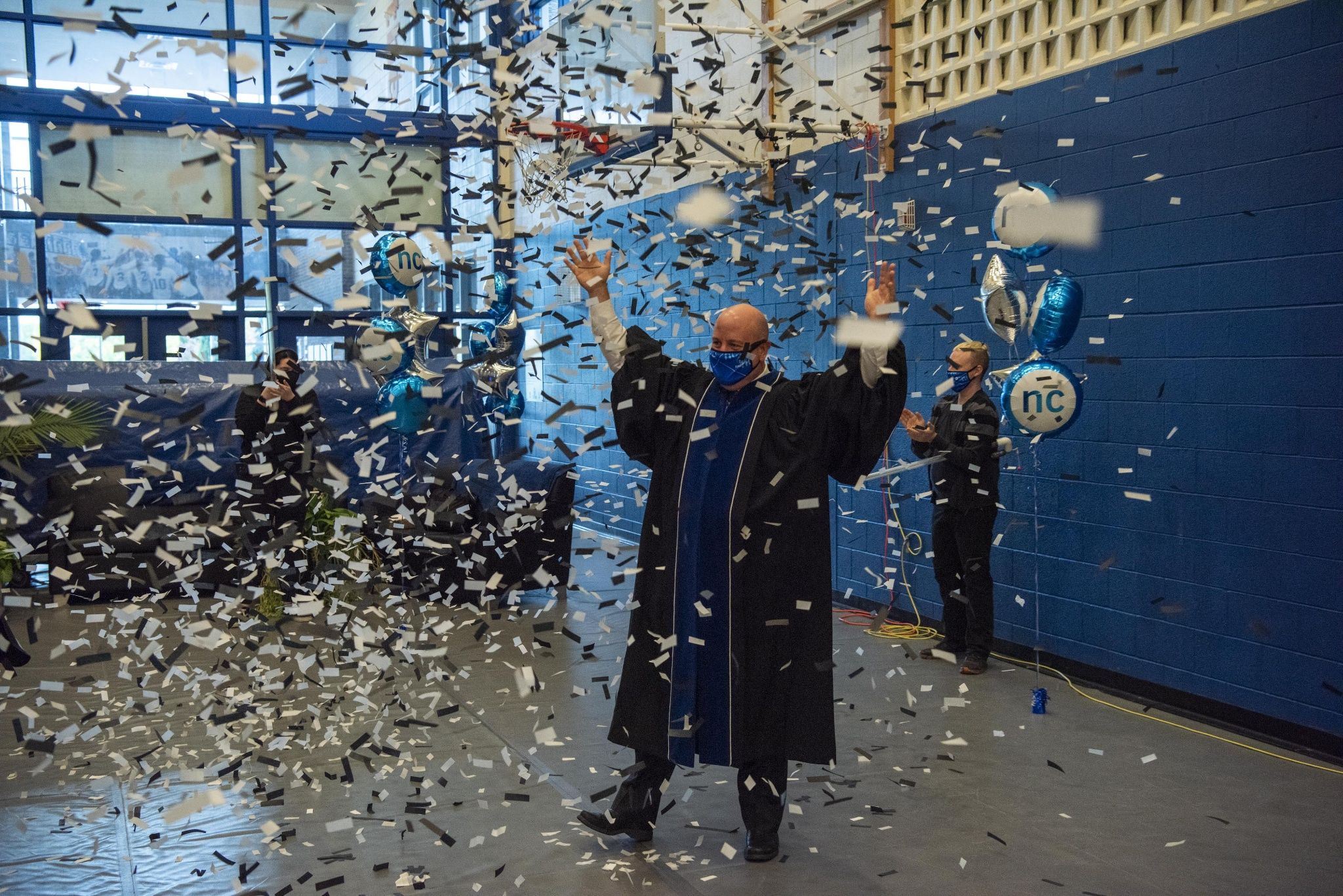 NC President Sean Kennedy excitedly celebrating Convocation in the gymnasium surrounded by balloons and falling confetti